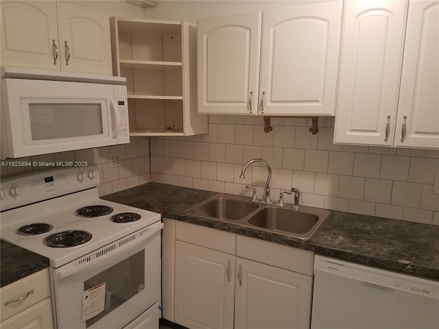 559 NW 44th St, Miami, FL 33127 - kitchen with white appliances, white cabinetry, open shelves, and dark countertops
