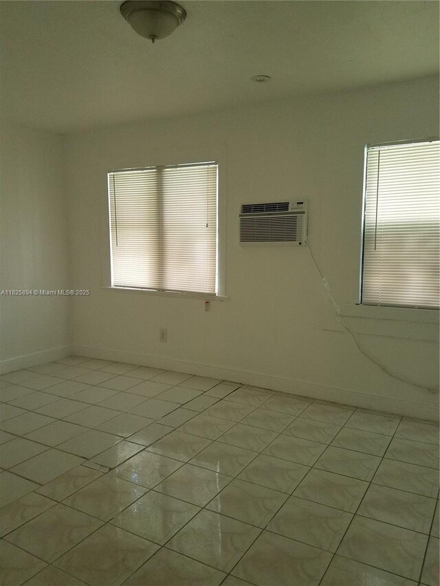 559 NW 44th St, Miami, FL 33127 - unfurnished room featuring a wall mounted AC and baseboards