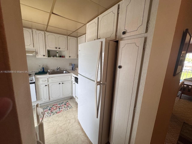 5200 Washington St Unit 207, Hollywood, FL 33021 - kitchen with white appliances, under cabinet range hood, light countertops, white cabinetry, and open shelves