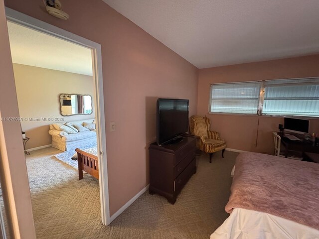 5200 Washington St Unit 207, Hollywood, FL 33021 - carpeted bedroom featuring lofted ceiling and baseboards