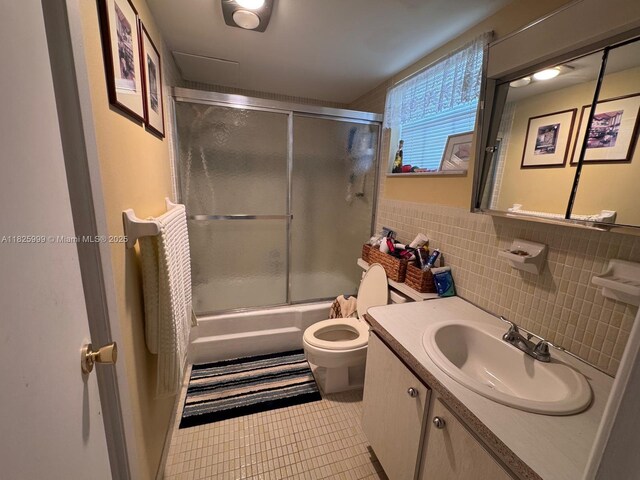 5200 Washington St Unit 207, Hollywood, FL 33021 - bathroom with tile patterned floors, vanity, enclosed tub / shower combo, tile walls, and wainscoting