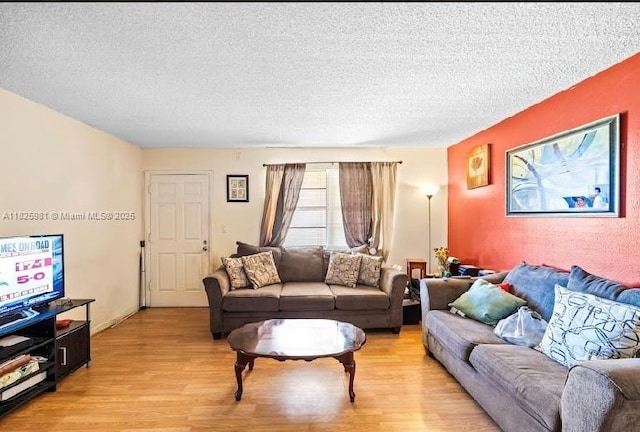 301 NW 177th St Unit 227, Miami Gardens, FL 33169 - living area featuring light wood-style floors and a textured ceiling