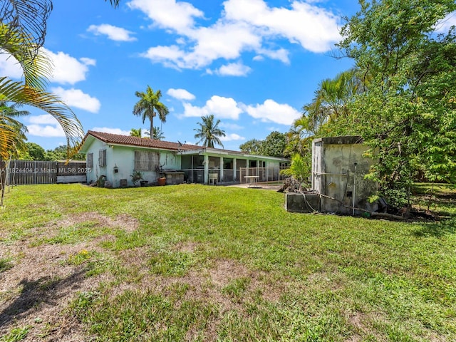 17430 SW 92nd Ct, Palmetto Bay, FL 33157 - rear view of house featuring a sunroom, stucco siding, and a fenced backyard