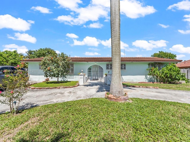 17430 SW 92nd Ct, Palmetto Bay, FL 33157 - view of front of property featuring stucco siding, driveway, a fenced front yard, and a tile roof