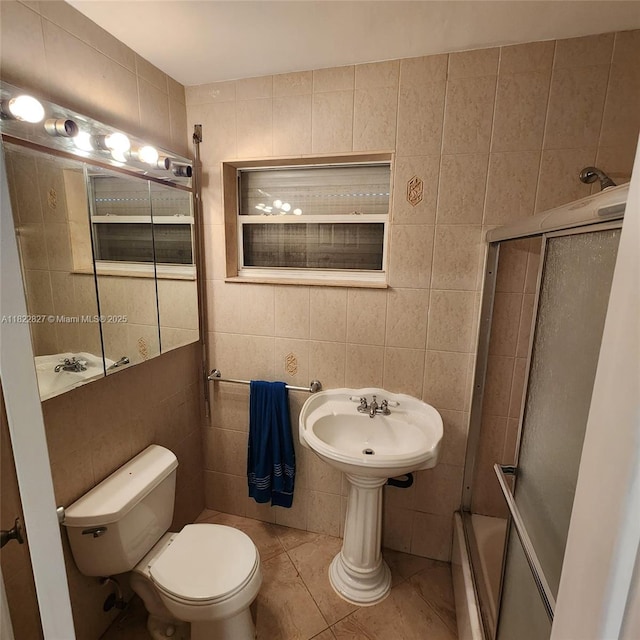 1843 Wiley St, Hollywood, FL 33020 - bathroom with tile walls, tile patterned floors, and combined bath / shower with glass door