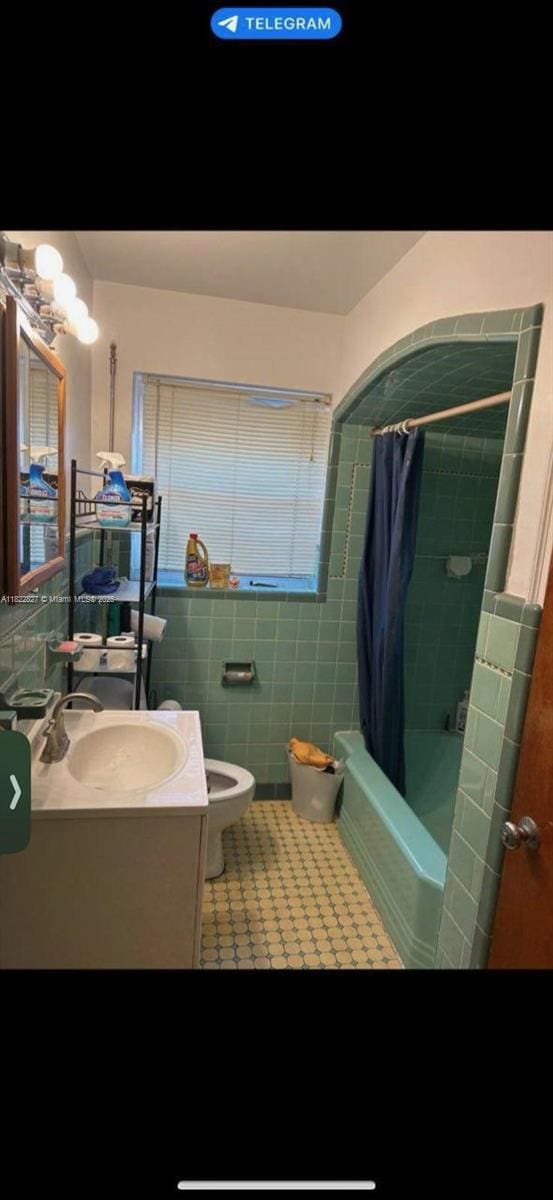 1843 Wiley St, Hollywood, FL 33020 - bathroom featuring tile walls, vanity, shower / bathtub combination with curtain, tile patterned floors, and a chandelier