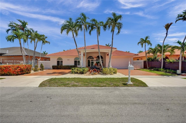 14241 SW 30th St, Miami, FL 33175 - mediterranean / spanish-style home featuring driveway, a tiled roof, stucco siding, and an attached garage