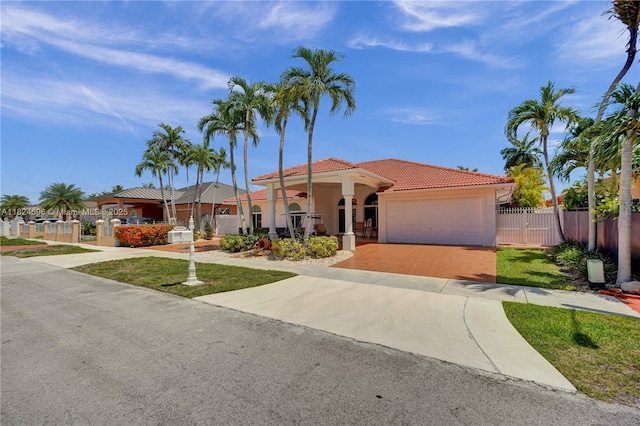 14241 SW 30th St, Miami, FL 33175 - mediterranean / spanish-style home with a tile roof, a garage, driveway, stucco siding, and a gate