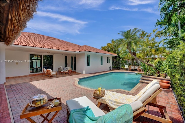 14241 SW 30th St, Miami, FL 33175 - view of swimming pool featuring an outdoor living space and a patio area