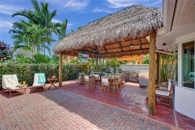 14241 SW 30th St, Miami, FL 33175 - fenced backyard with a gazebo, outdoor dining area, a patio, and exterior kitchen