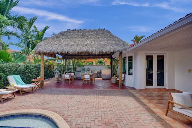 14241 SW 30th St, Miami, FL 33175 - fenced backyard with french doors, a gazebo, a patio, and outdoor dining space