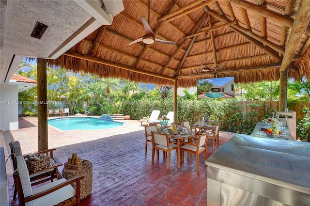 14241 SW 30th St, Miami, FL 33175 - fenced backyard featuring a gazebo, outdoor dining space, ceiling fan, and a patio area