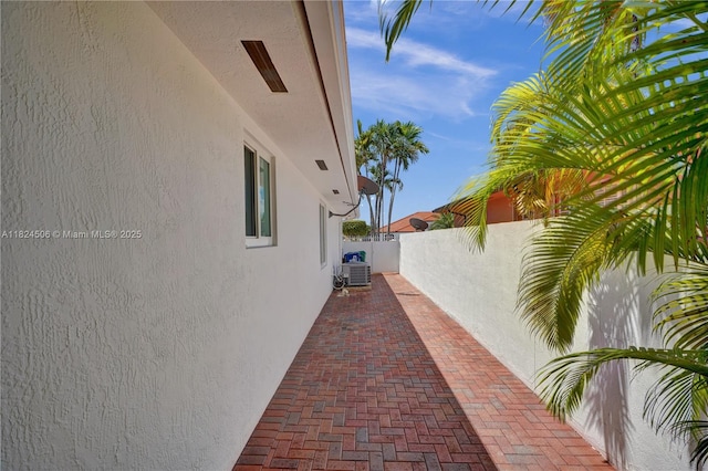 14241 SW 30th St, Miami, FL 33175 - view of side of home featuring stucco siding and a patio area