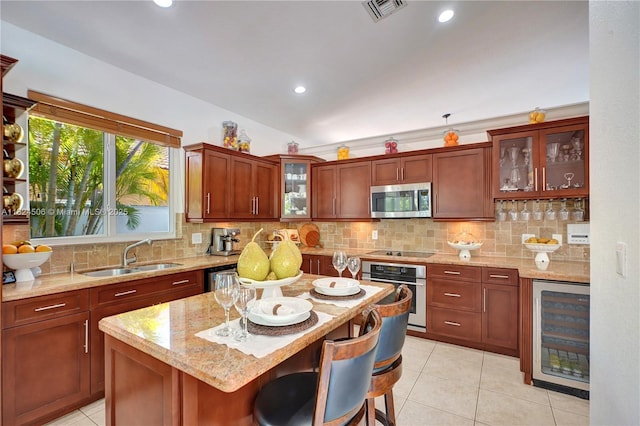 14241 SW 30th St, Miami, FL 33175 - kitchen with appliances with stainless steel finishes, beverage cooler, light tile patterned flooring, light stone countertops, and decorative backsplash