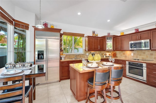 14241 SW 30th St, Miami, FL 33175 - kitchen with stainless steel appliances, tasteful backsplash, a center island, light stone counters, and recessed lighting