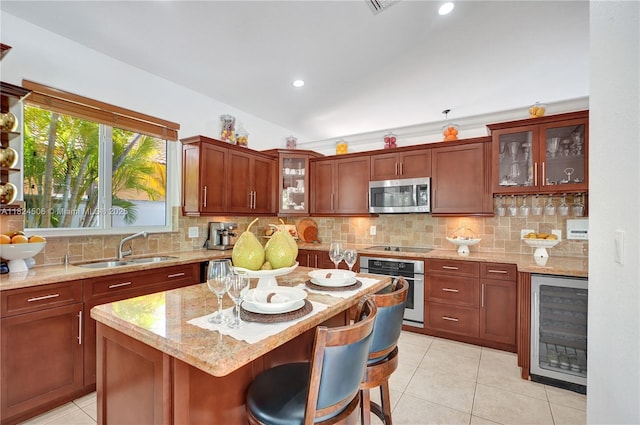 14241 SW 30th St, Miami, FL 33175 - kitchen with stainless steel appliances, beverage cooler, light tile patterned flooring, light stone countertops, and decorative backsplash