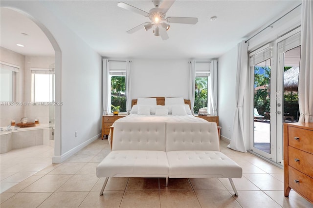 14241 SW 30th St, Miami, FL 33175 - bedroom with arched walkways, access to outside, light tile patterned floors, ensuite bath, and a ceiling fan