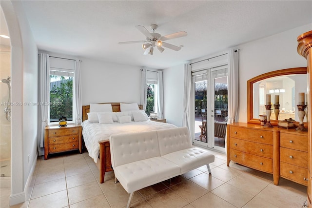 14241 SW 30th St, Miami, FL 33175 - bedroom featuring access to exterior, arched walkways, light tile patterned floors, and a ceiling fan
