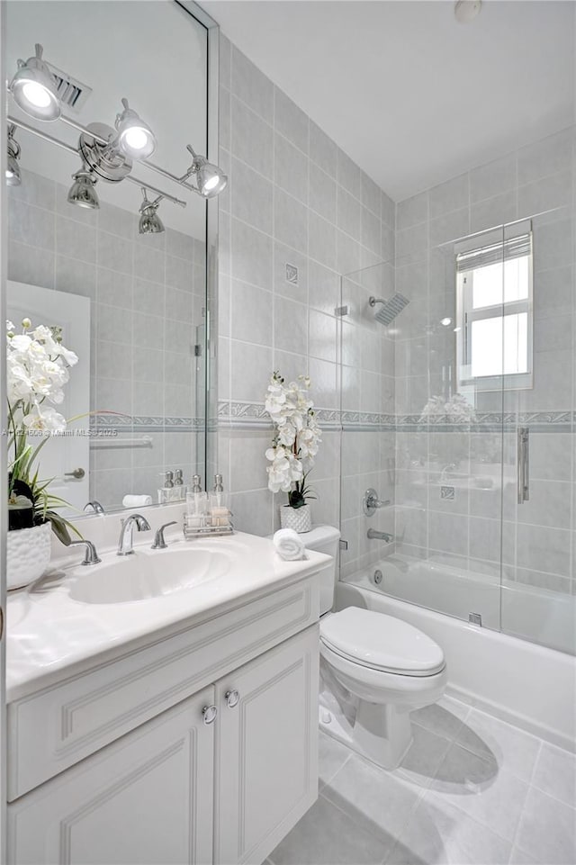 14241 SW 30th St, Miami, FL 33175 - full bathroom with tile walls, vanity, shower / tub combination, and tile patterned flooring