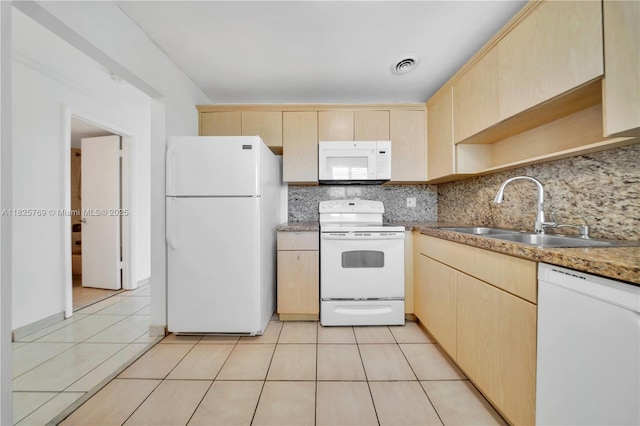 7830 Dickens Ave Unit 504, Miami Beach, FL 33141 - kitchen featuring white appliances, light brown cabinets, and backsplash