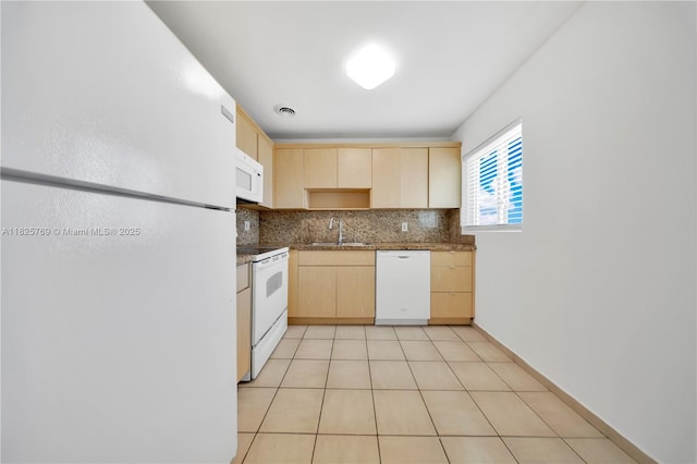 7830 Dickens Ave Unit 504, Miami Beach, FL 33141 - kitchen with white appliances, light brown cabinetry, tasteful backsplash, dark stone countertops, and light tile patterned flooring