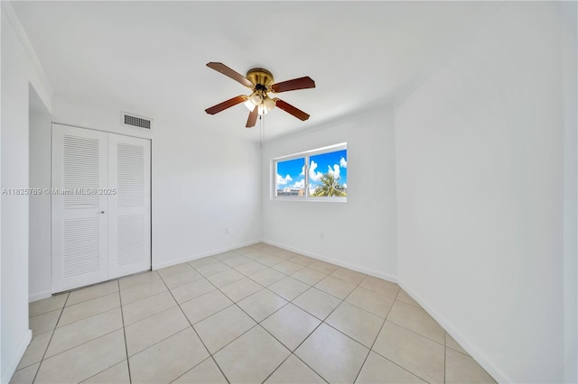 7830 Dickens Ave Unit 504, Miami Beach, FL 33141 - unfurnished bedroom featuring a closet, light tile patterned flooring, and ceiling fan