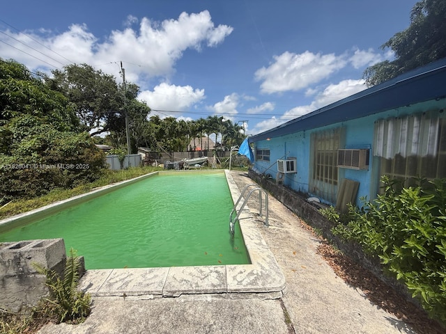 10315 SW 42nd St, Miami, FL 33165 - view of swimming pool featuring cooling unit and a wall mounted AC