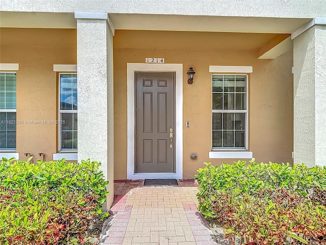 1214 SW 147th Ter, Pembroke Pines, FL 33027 - doorway to property featuring stucco siding and a porch