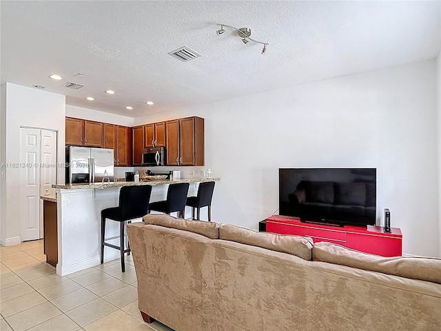 1214 SW 147th Ter, Pembroke Pines, FL 33027 - living area featuring light tile patterned flooring, recessed lighting, and a textured ceiling