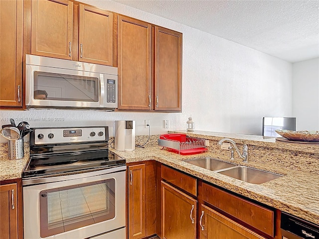 1214 SW 147th Ter, Pembroke Pines, FL 33027 - kitchen featuring appliances with stainless steel finishes, a textured ceiling, brown cabinetry, and light stone counters