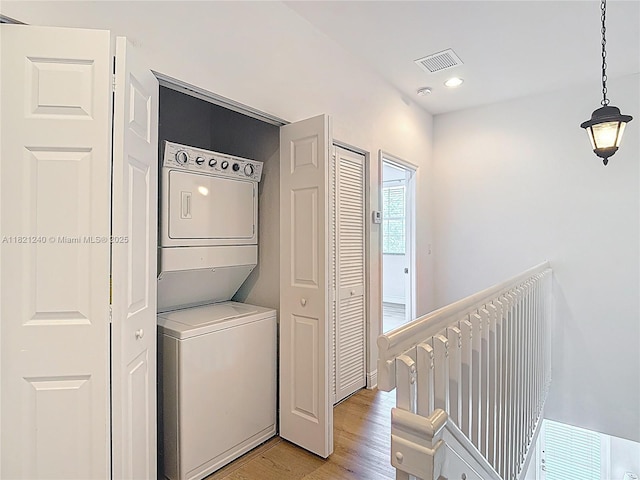 1214 SW 147th Ter, Pembroke Pines, FL 33027 - washroom featuring stacked washer and clothes dryer, light wood finished floors, and recessed lighting