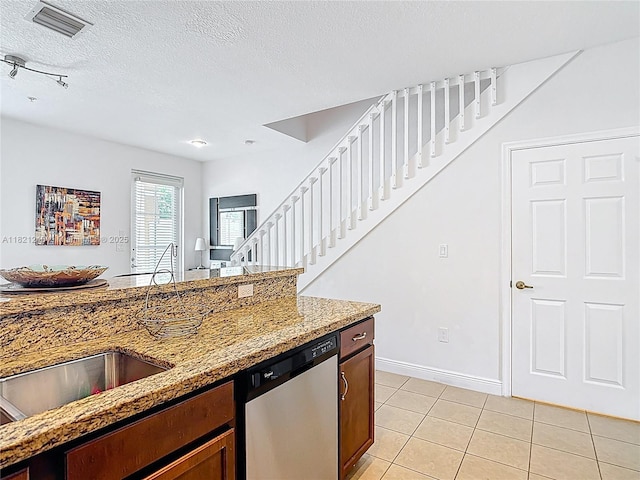 1214 SW 147th Ter, Pembroke Pines, FL 33027 - kitchen featuring stainless steel dishwasher, light stone counters, light tile patterned floors, and a textured ceiling