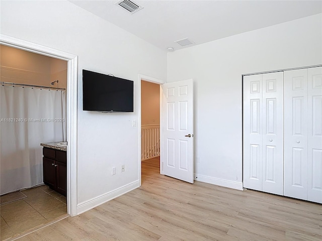 1214 SW 147th Ter, Pembroke Pines, FL 33027 - unfurnished bedroom with light wood-style floors, a closet, and connected bathroom