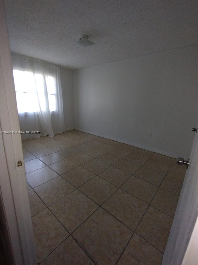 2775 L B Mcleod St Unit B, Orlando, FL 32805 - spare room with tile patterned floors and a textured ceiling