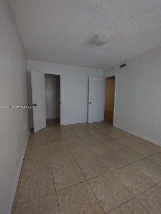 2775 L B Mcleod St Unit B, Orlando, FL 32805 - spare room with a textured ceiling and light tile patterned floors
