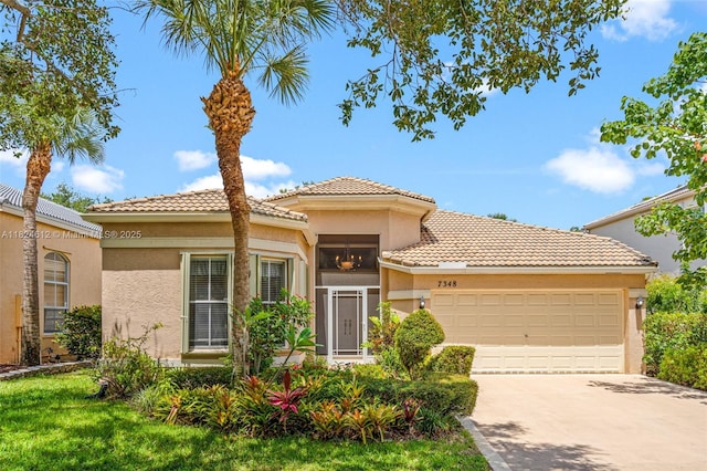 7348 Copperfield Cir, Lake Worth, FL 33467 - view of front of house with a garage, concrete driveway, stucco siding, and a tile roof