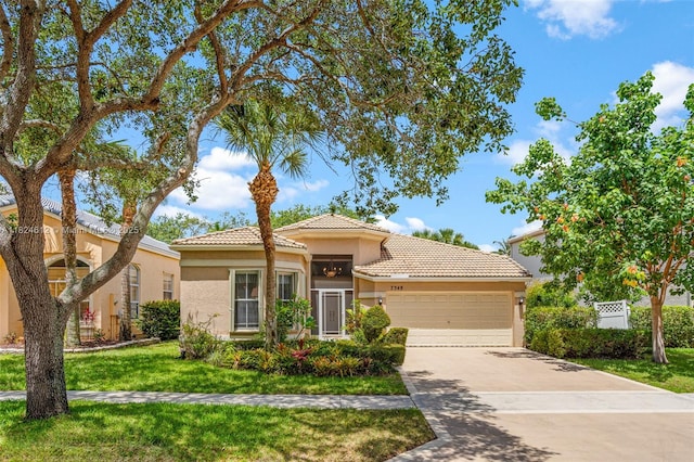 7348 Copperfield Cir, Lake Worth, FL 33467 - mediterranean / spanish-style home featuring a tiled roof, a garage, stucco siding, driveway, and a front yard