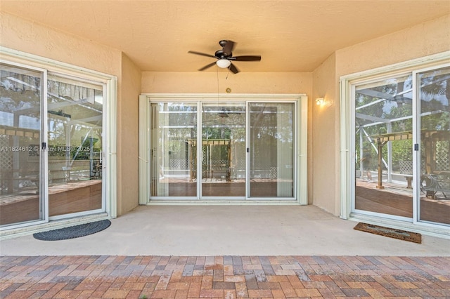 7348 Copperfield Cir, Lake Worth, FL 33467 - view of exterior entry featuring ceiling fan, stucco siding, and a patio