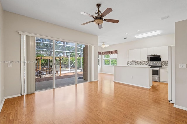 7348 Copperfield Cir, Lake Worth, FL 33467 - unfurnished living room featuring light wood-style flooring, ceiling fan, and recessed lighting
