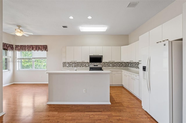 7348 Copperfield Cir, Lake Worth, FL 33467 - kitchen with white refrigerator with ice dispenser, stainless steel electric range, light wood-type flooring, tasteful backsplash, and light countertops