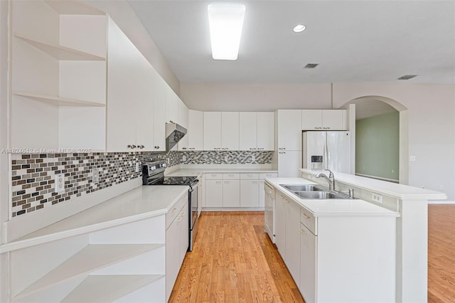 7348 Copperfield Cir, Lake Worth, FL 33467 - kitchen with appliances with stainless steel finishes, open shelves, arched walkways, a kitchen island with sink, and extractor fan