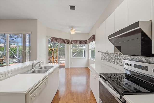 7348 Copperfield Cir, Lake Worth, FL 33467 - kitchen featuring stainless steel range with electric cooktop, dishwasher, ceiling fan, extractor fan, and light wood finished floors
