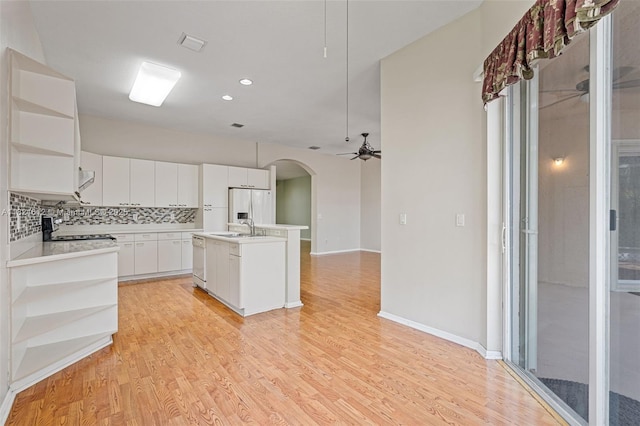 7348 Copperfield Cir, Lake Worth, FL 33467 - kitchen with open shelves, a ceiling fan, fridge with ice dispenser, arched walkways, and recessed lighting