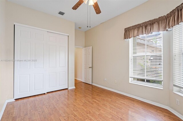 7348 Copperfield Cir, Lake Worth, FL 33467 - unfurnished bedroom with light wood-type flooring, a closet, and a ceiling fan