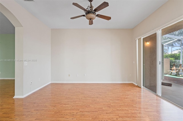 7348 Copperfield Cir, Lake Worth, FL 33467 - unfurnished room featuring arched walkways, light wood-style floors, and ceiling fan