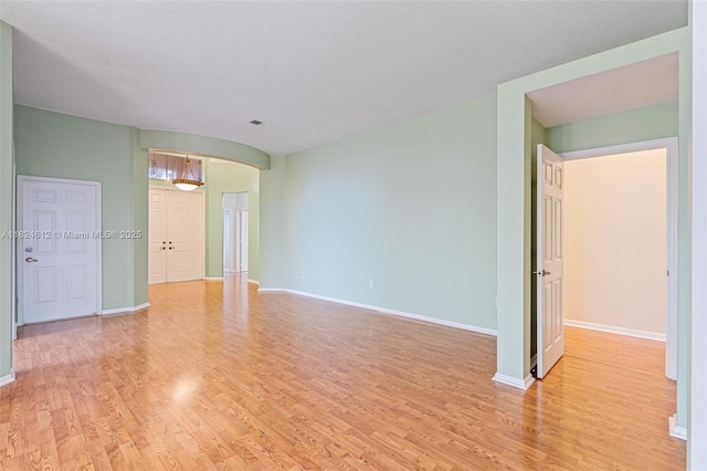 7348 Copperfield Cir, Lake Worth, FL 33467 - spare room featuring arched walkways and light wood-style floors