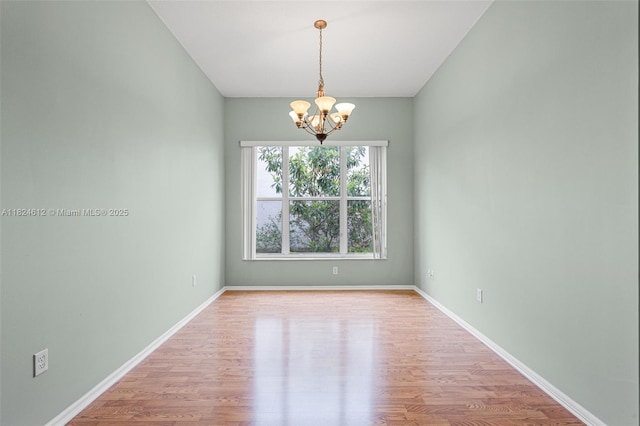 7348 Copperfield Cir, Lake Worth, FL 33467 - unfurnished room with a chandelier and wood finished floors