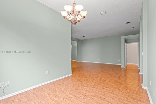 7348 Copperfield Cir, Lake Worth, FL 33467 - unfurnished room with light wood-style floors and a chandelier