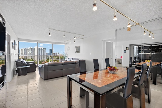 3701 N Country Club Dr Unit 2209, Aventura, FL 33180 - dining room featuring rail lighting, a city view, a textured ceiling, and light tile patterned floors
