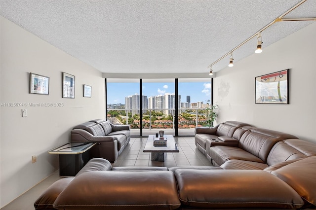 3701 N Country Club Dr Unit 2209, Aventura, FL 33180 - living room featuring floor to ceiling windows, tile patterned floors, a skyline view, and a textured ceiling
